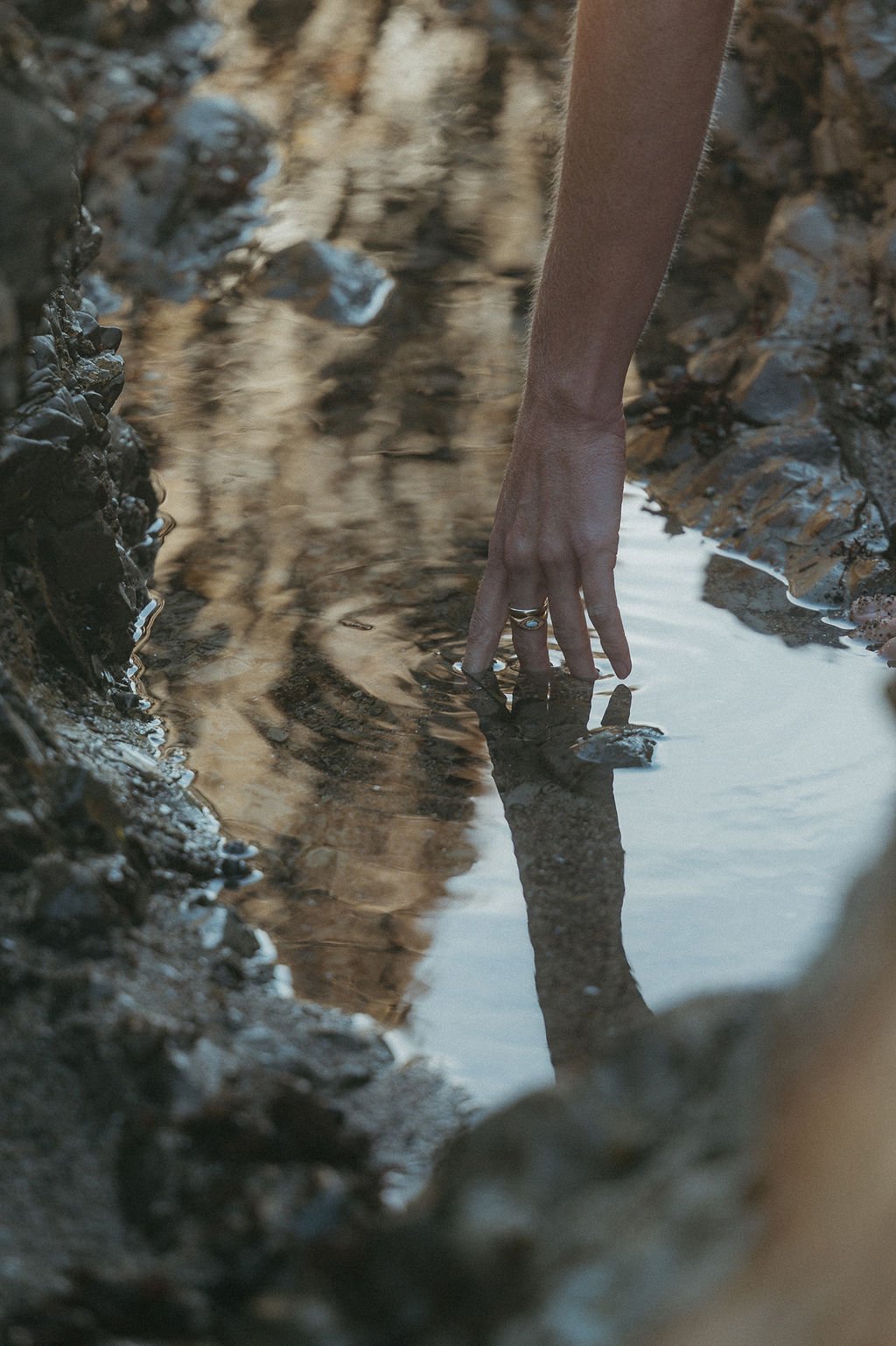 Hand touching still water